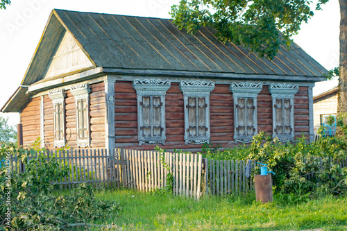 Carved wooden trim of the facade of the old house. House with carved wooden facade, Belarus © chaiko