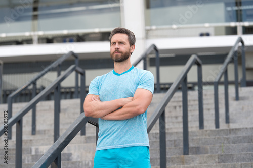 Handsome athlete beard man standing confidently. Staying fit and healthy. having a good sport shape. he is always in great shape. serious bearded man crossed hands. feeling confident and successful