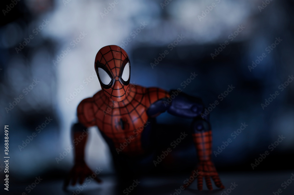 Naklejka premium NEW YORK USA - AUGUST 2 2020: Scene with Marvel comic superhero Spiderman scaling the side of a skyscraper - Hasbro Marvel Legends figure