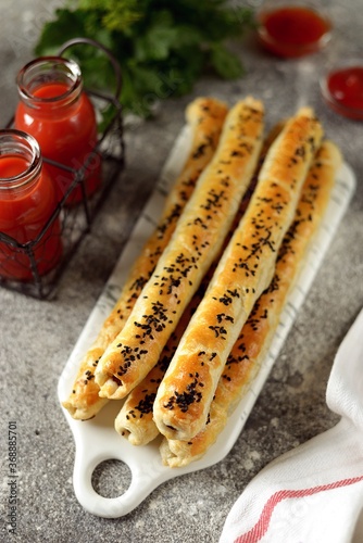 Puff pastry rollini with mushrooms, sesame seeds and tomato juice. photo