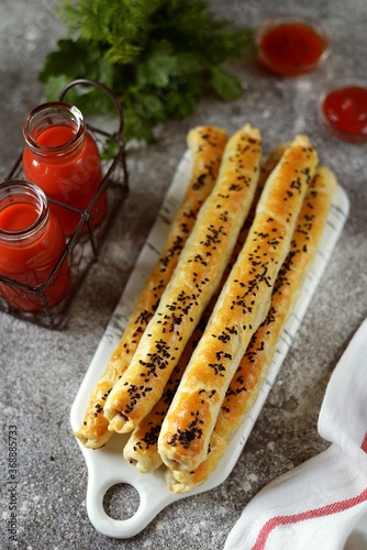 Puff pastry rollini with mushrooms, sesame seeds and tomato juice. photo