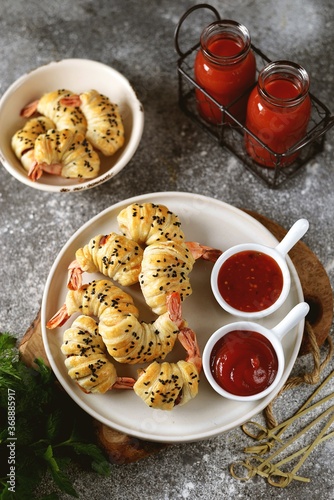 Tiger shrimp tails in Parma ham or jamon and puff pastry. Delicious homemade appetizer.