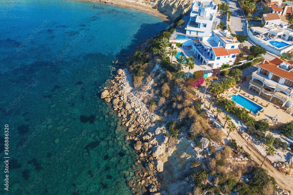 Aerial view of Cyprus coastline with new modern buildings and villas and blue sea.