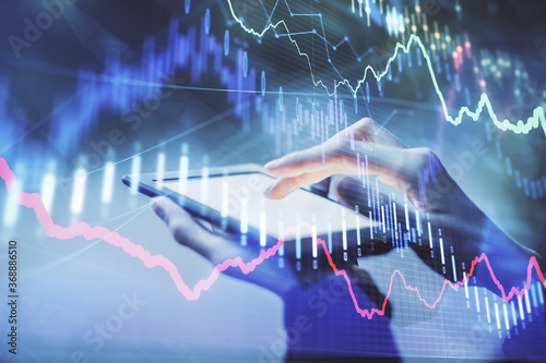 Double exposure of forex chart sketch hologram and woman holding and using a mobile device. Financial market concept.