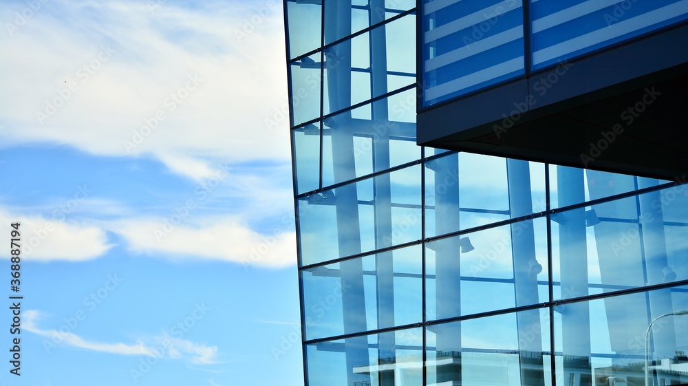 Commercial building close up. Abstract texture of blue glass modern building. Business background. Commercial building close up. Abstract texture of blue glass modern building. Business background.