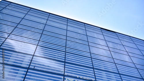 Commercial building close up. Abstract texture of blue glass modern building. Business background.