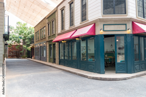 Deserted street with commercial establishments. coffee shop, cinema, convenience store. TV set.