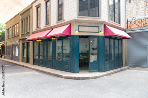 Deserted street with commercial establishments. coffee shop, cinema, convenience store. TV set.