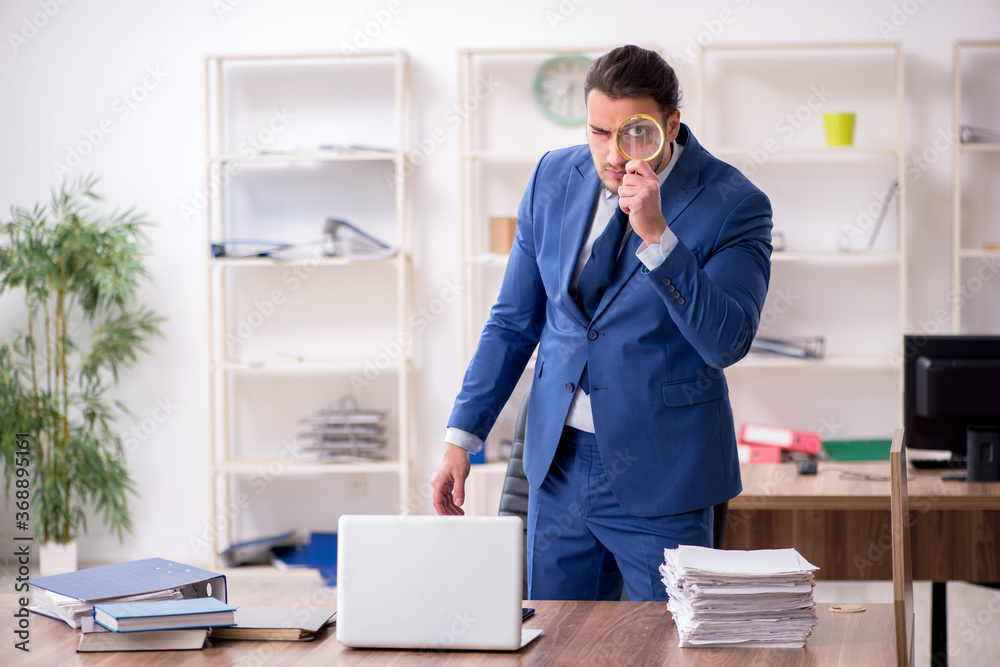Young male employee unhappy with excessive work Young male employee unhappy with excessive work