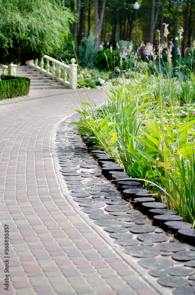 Obraz premium staircase with balusters in the city park by the pond