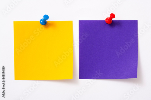 Note paper with pin on white background. 