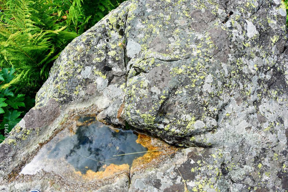 Small puddle in stones with sky reflection. Mountains of North Ossetia Small puddle in stones with sky reflection. Mountains of North Ossetia