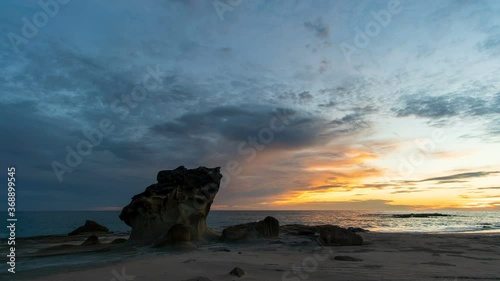 Time lapse: Sunset view on the ocean with reflection and silhouette. A beached foreground log adds interest. Slow motion timelapse 4K footage. Shot at 2160p.