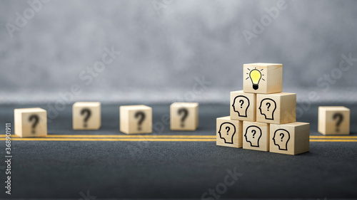 cubes showing a brainstorming session on asphalt surface and concrete background photo