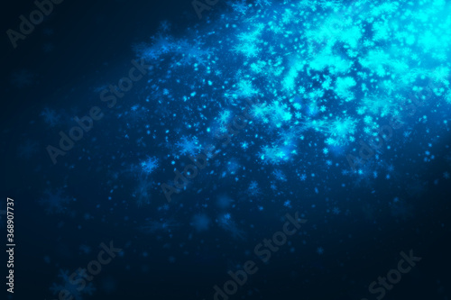 Blue many snowflakes differrent size falling from side scene with blue spot light on dark blue background