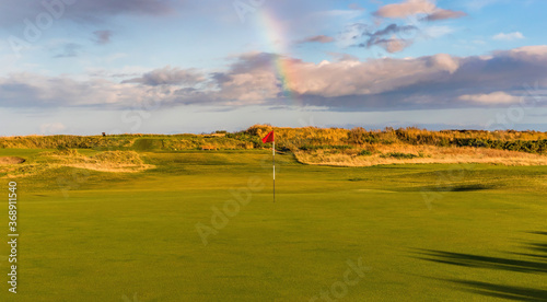 Links golf course with clouds and a rainbow