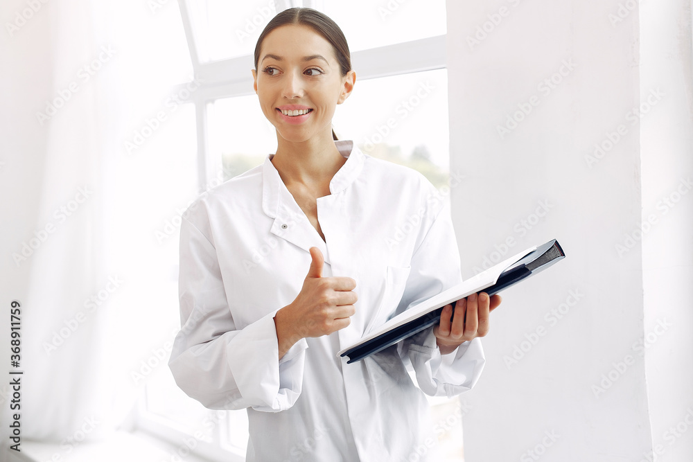 Lady in a uniform. Doctor on a white background. Woman hold a folder in her hands.