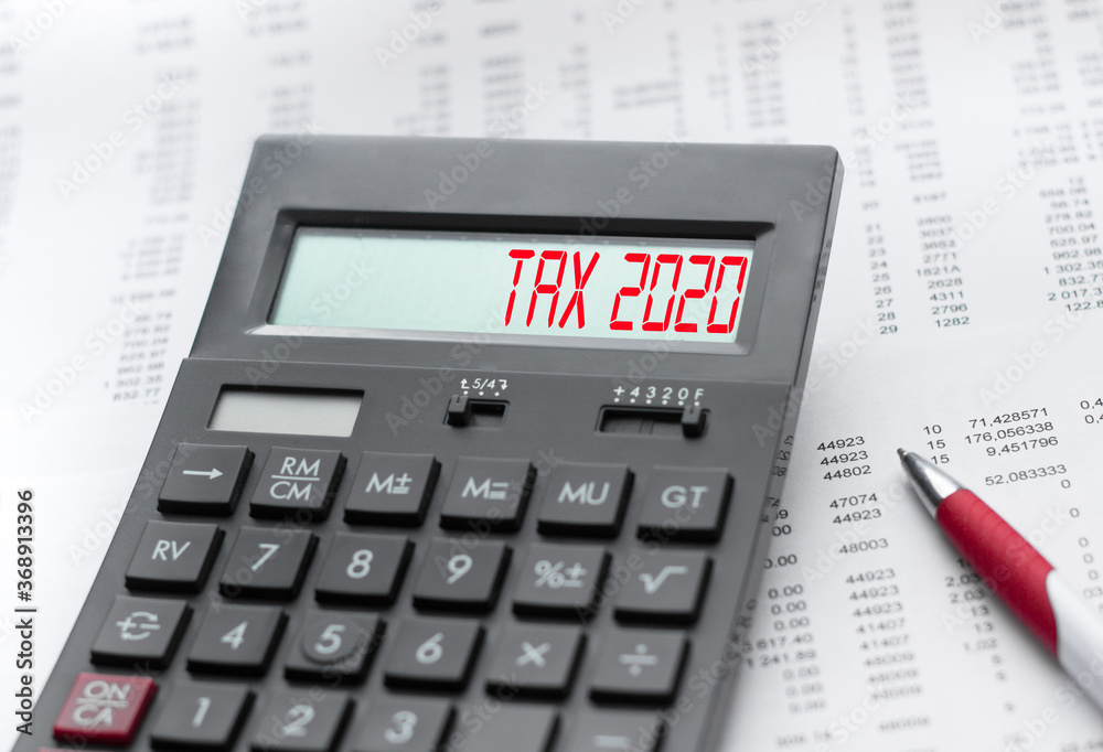 A calculator with the inscription TAX 2020 . Business profit concept A calculator with the inscription TAX 2020 . Business profit concept