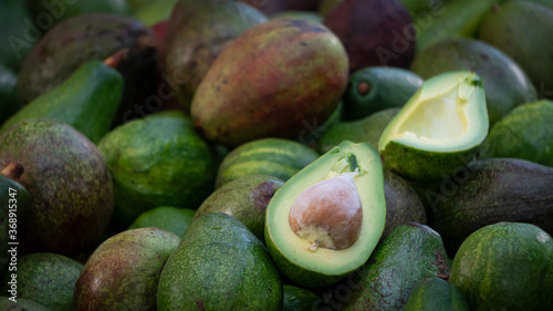 Green avocado piles of fruit sold on the streets of Thailand.