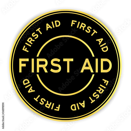 Black and gold color round sticker with word first aid on white background
