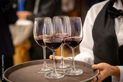 waiter serving glass of red wine © PRASERT