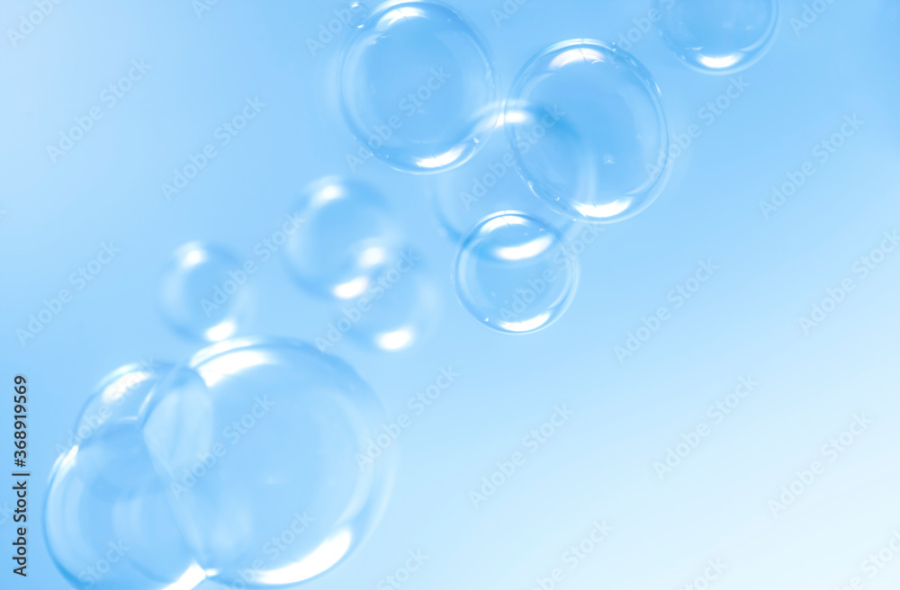 transparent clear blue soap bubbles float background.