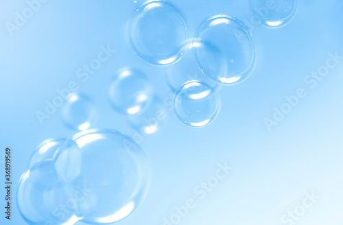 transparent clear blue soap bubbles float background.