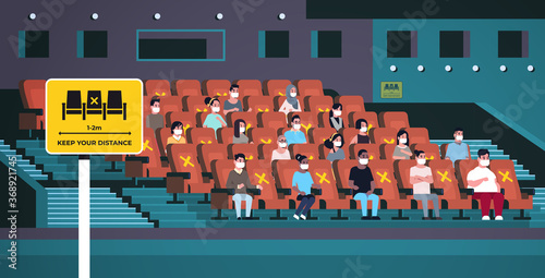 people in protective masks watching movie keeping distance to prevent coronavirus social distancing concept mix race men women sitting through one chair cinema hall interior horizontal full length