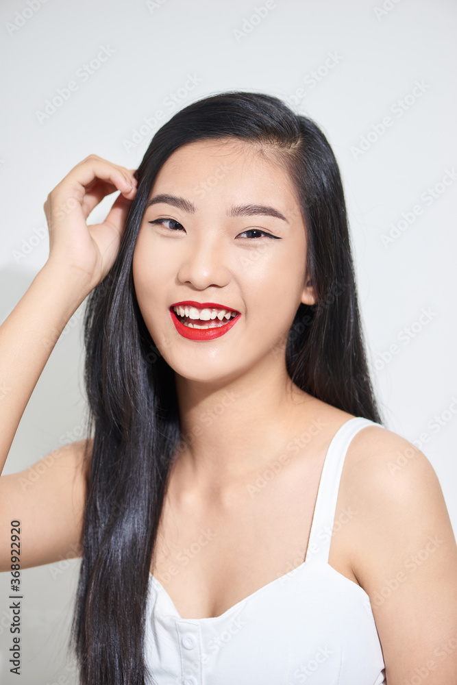 Beauty portrait of Asian female beauty model isolated on white background. Closeup of woman with long dark hair. Beauty portrait of Asian female beauty model isolated on white background. Closeup of woman with long dark hair.