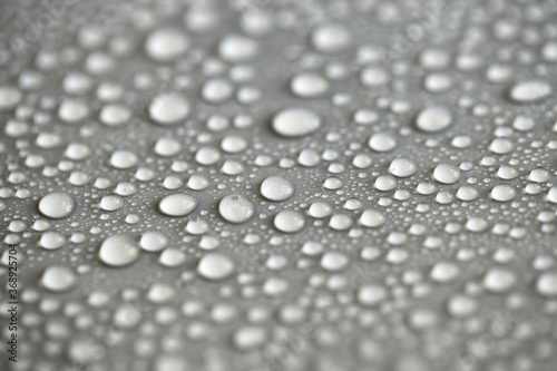 Water drops on light background, top view, close-up, macro. Great background with natural water drops and natural light