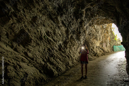 A tourist take a photo inside a tunnel at Baiyang Trail of Taroko National Park in Hualien county, Taiwan.