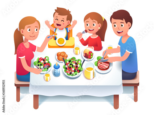 Father, mother, kids having family dinner or lunch