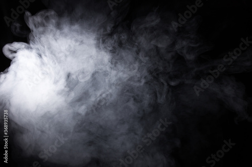 Cloud of white smoke on a black background closeup © vfhnb12