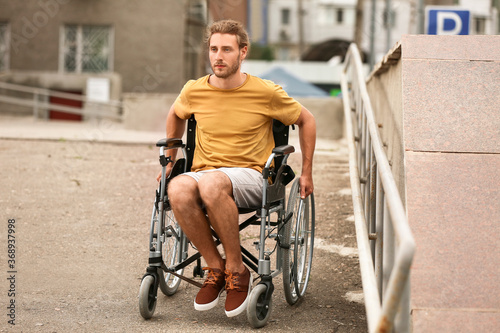 Young man in wheelchair out...