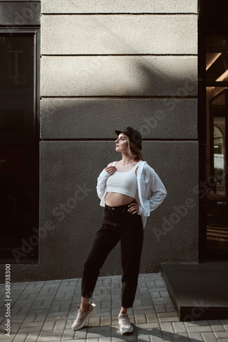 fashion portrait of young stylish beautiful woman in a urban background