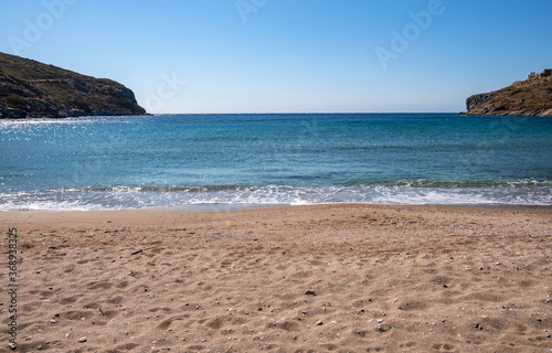 Sandy beach, blue clear sky, calm sea water background, Greece. Kea island,