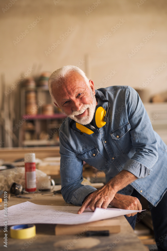 Portrait of a nice elderly carpenter smiling Portrait of a nice elderly carpenter smiling