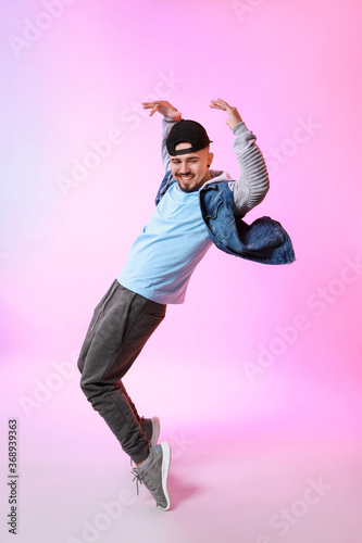 Male hip-hop dancer on color background