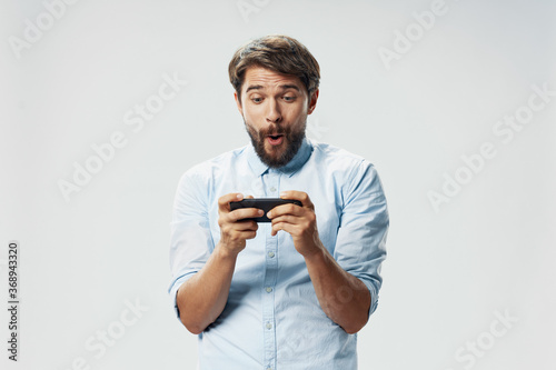 A bearded man holds a smartphone in his hands internet smart appliances 