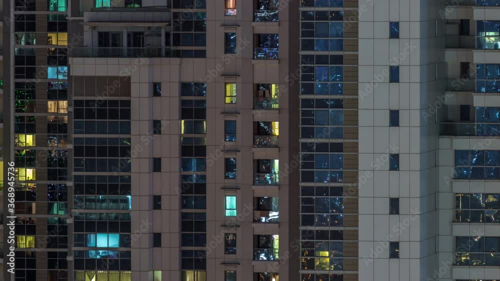 Lights from windows of offices and apartments aerial timelapse. Skyscrapers with working people in the evening in Business Bay, Dubai, United Arab Emirates. Complex of towers at night Lights from windows of offices and apartments aerial timelapse. Skyscrapers with working people in the evening in Business Bay, Dubai, United Arab Emirates. Complex of towers at night