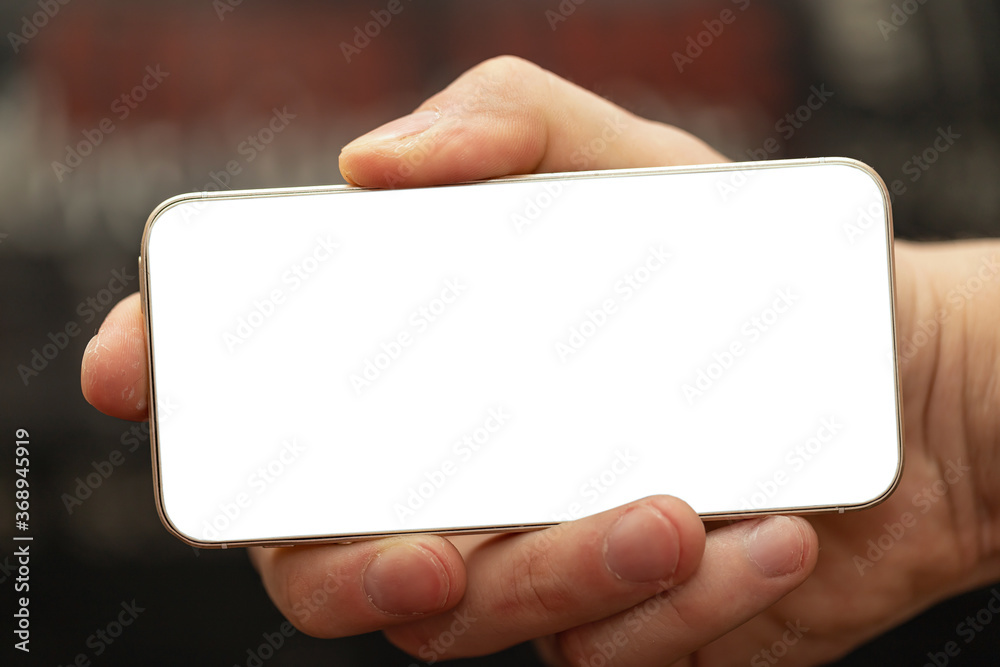 Closeup of male hand holding and using modern smart phone Closeup of male hand holding and using modern smart phone