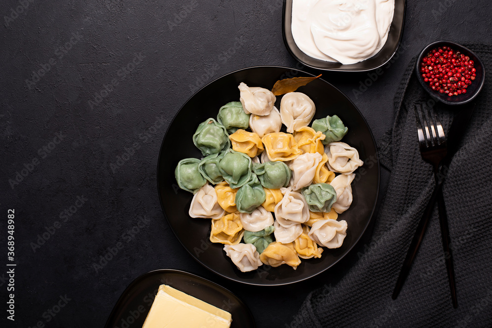 boiled homemade colorful meat dumplings in a black plate boiled homemade colorful meat dumplings in a black plate