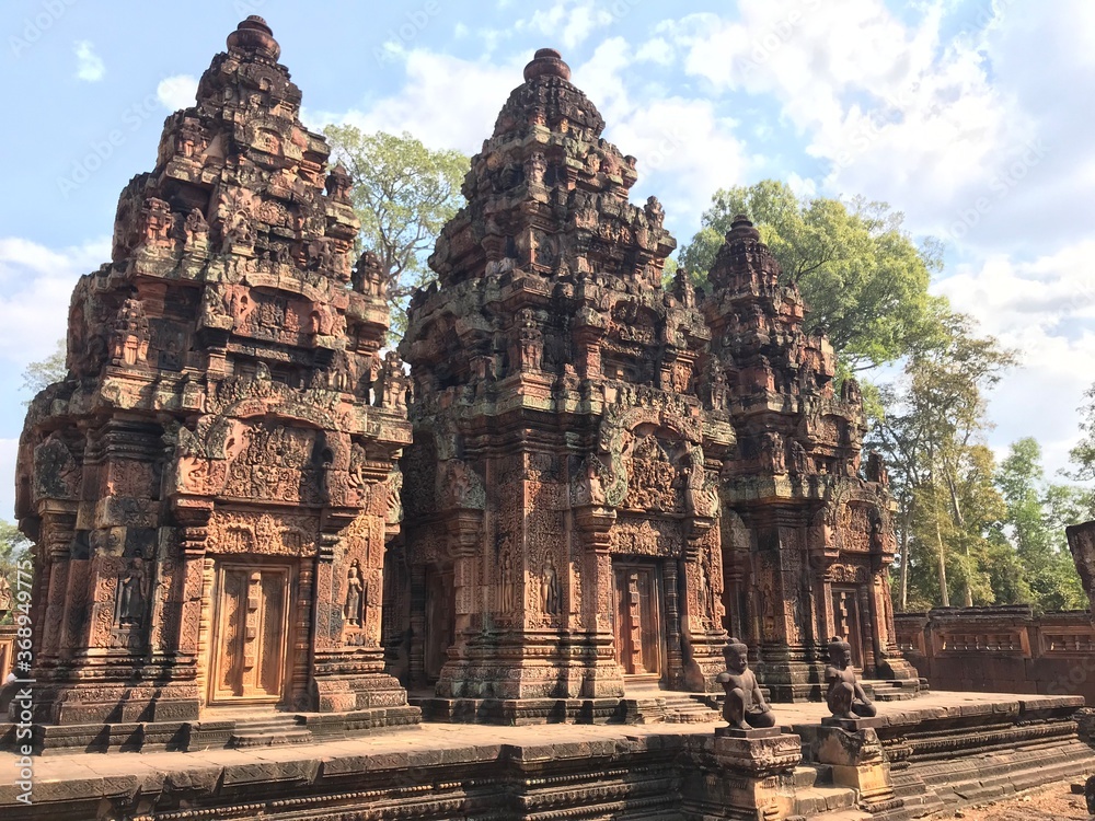 Historic Site in Cambodia, Citadel of the women, the pink color of the limestone and the elaborate decorative carvings of many female deities that grace its walls.  