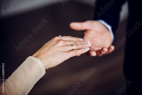 a man and a woman reach out to each other, two people holding hands, the concept of friendship, lend a helping hand, blurred background, outdoors