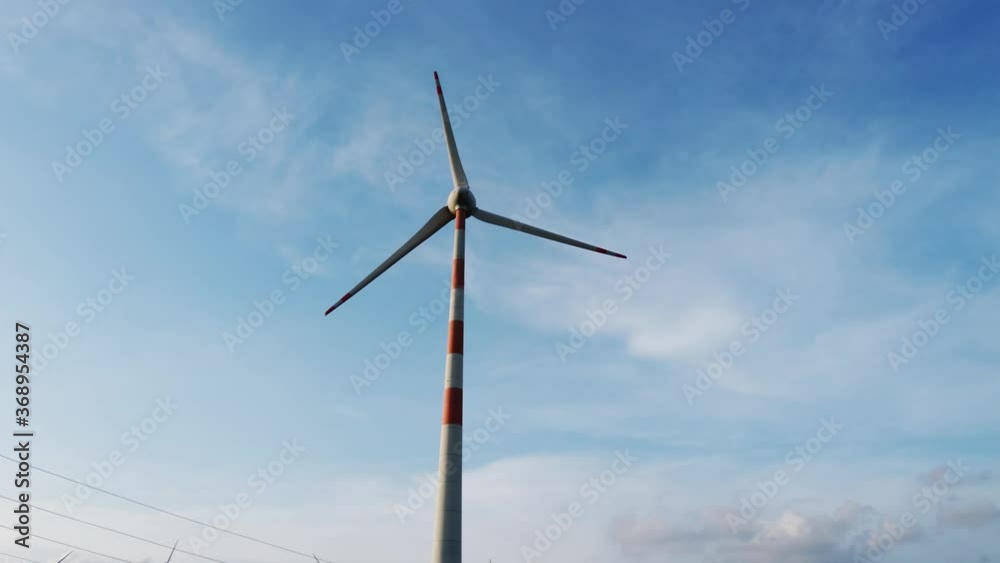 Windmill from a wind farm in India, natural renewable energy, clean and green energy to power homes - footage for presentation. Windmill from a wind farm in India, natural renewable energy, clean and green energy to power homes - footage for presentation.