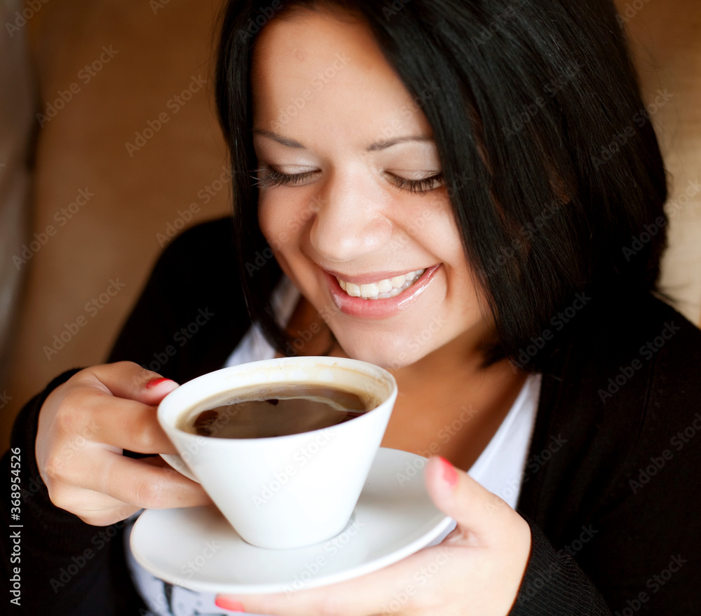 young woman sitting in a cafe drinking coffee young woman sitting in a cafe drinking coffee