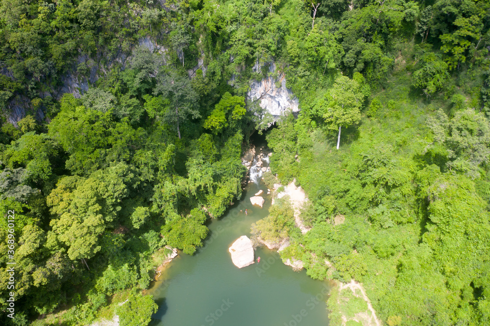 Aerial view from drone show view of blue lagoon from cave at mountain in Laos.