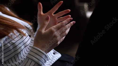 Close-up of unrecognizable young woman moving and gesturing hands during meeting. Lady nervously moving hands during meeting with psychologist while sitting on couch in office. Shooting in slow motion