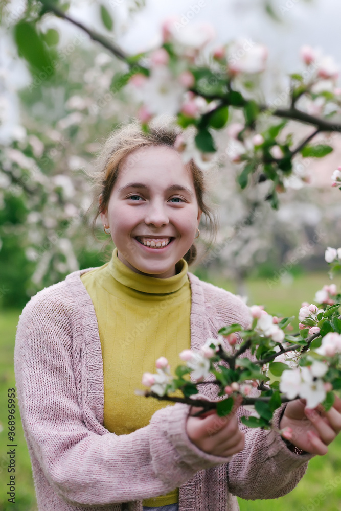 young girl in apple orchard in village. young girl in apple orchard in village.