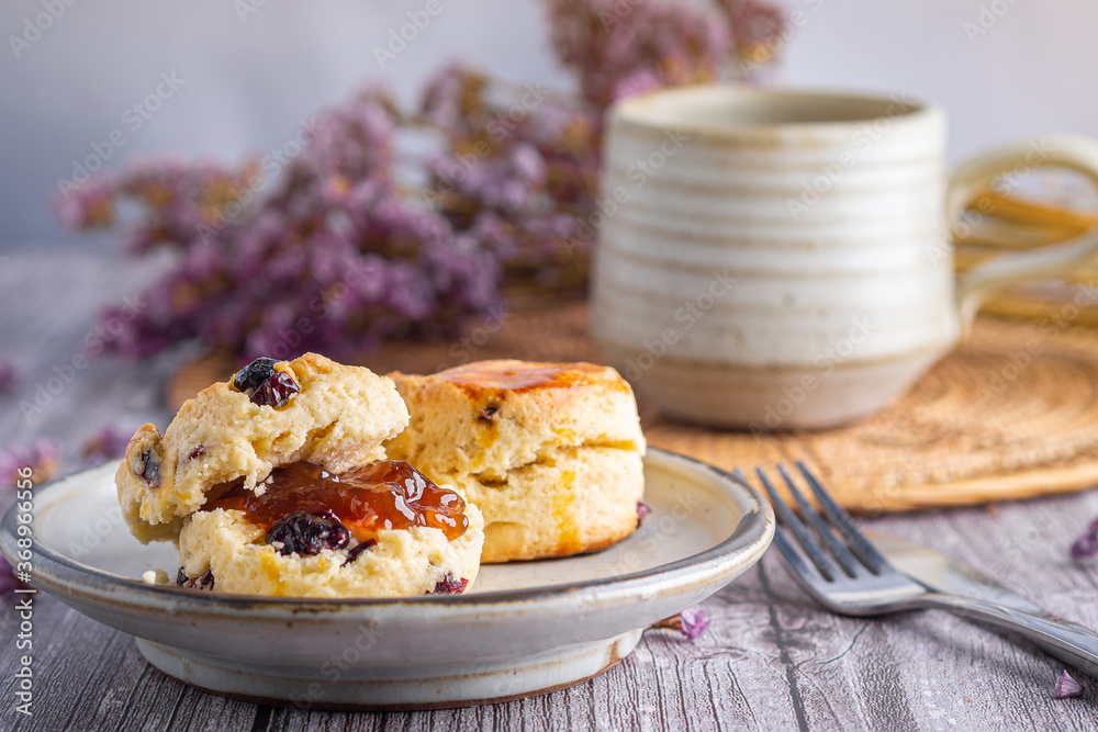 Traditional British scones with a tea cup and blurred background Traditional British scones with a tea cup and blurred background